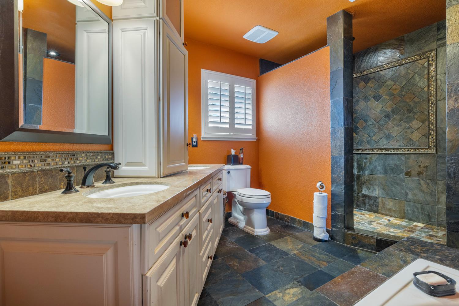 1084 Eastburg Court Ripon, CA 95366 - Photo 29 of 46 a bathroom with a granite countertop sink and a mirror