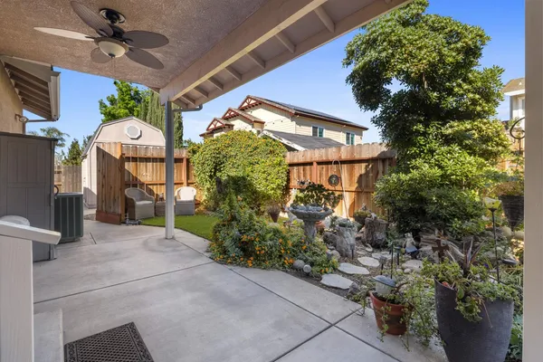 a front view of a house with plants