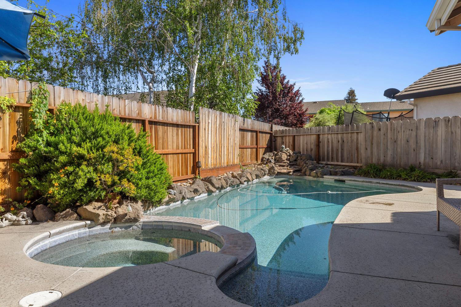 1084 Eastburg Court Ripon, CA 95366 - Photo 38 of 46 a swimming pool with outdoor seating and yard