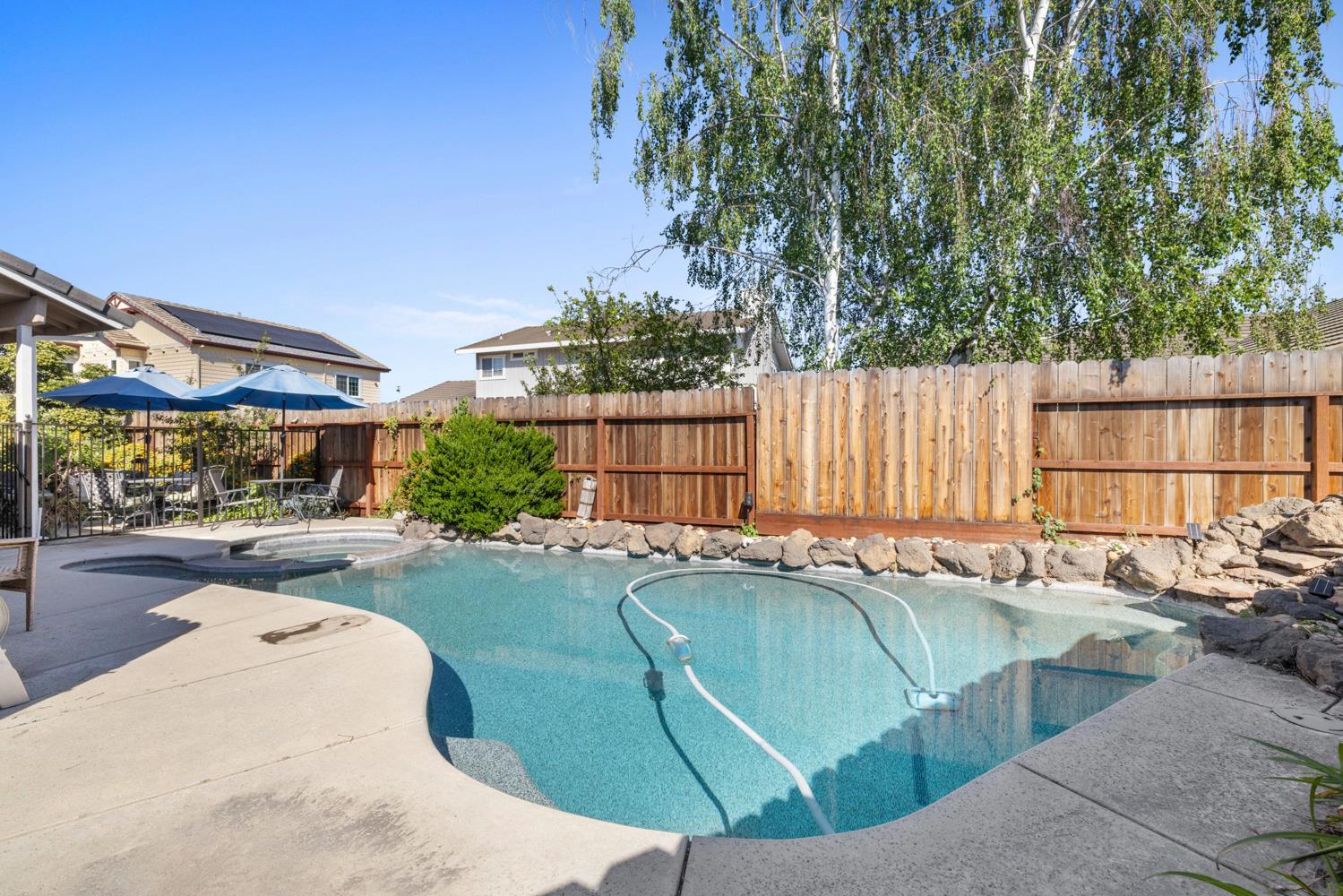 1084 Eastburg Court Ripon, CA 95366 - Photo 40 of 46 a view of a swimming pool with a patio