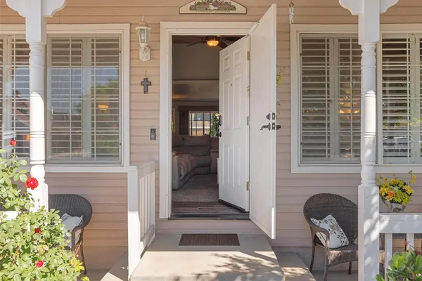 a front view of a house with outdoor seating and plants