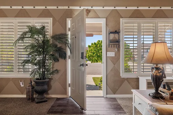 a view of a workspace with furniture and a potted plant