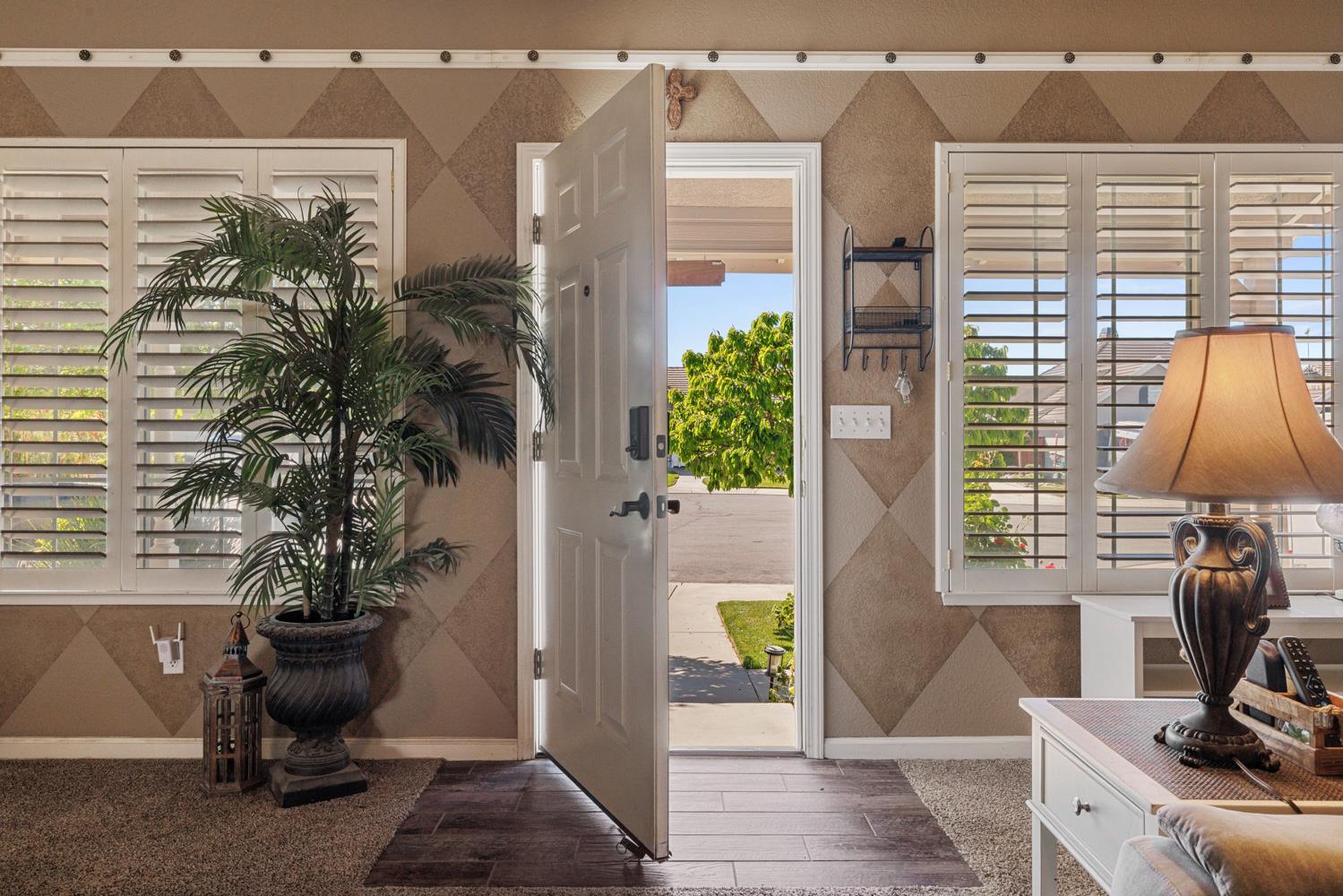 1084 Eastburg Court Ripon, CA 95366 - Photo 5 of 46 a view of a workspace with furniture and a potted plant