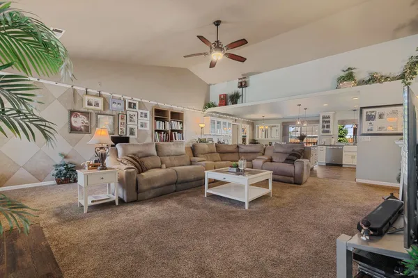 a living room with furniture and a chandelier