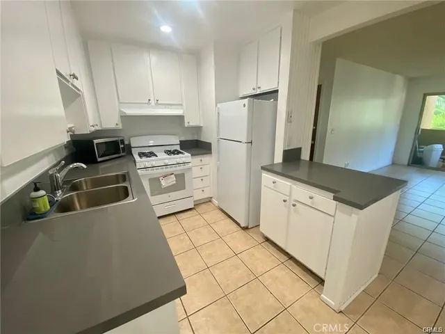 a kitchen with a stove top oven and cabinets