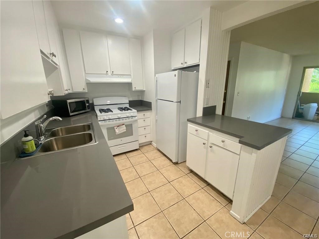 a kitchen with a stove top oven and cabinets