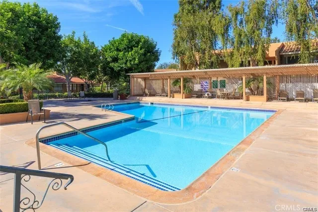 a view of a house with pool and sitting area