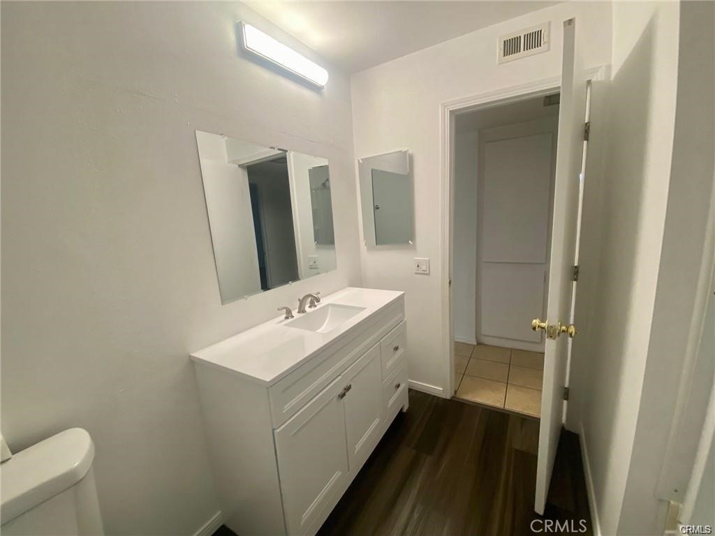 1101 West MacArthur Boulevard Santa Ana, CA 92707 - Photo 5 of 16 a bathroom with a sink a toilet and shower