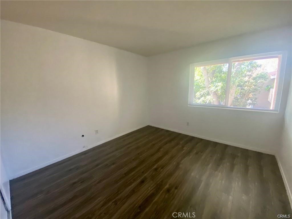 1101 West MacArthur Boulevard Santa Ana, CA 92707 - Photo 6 of 16 an empty room with wooden floor and windows