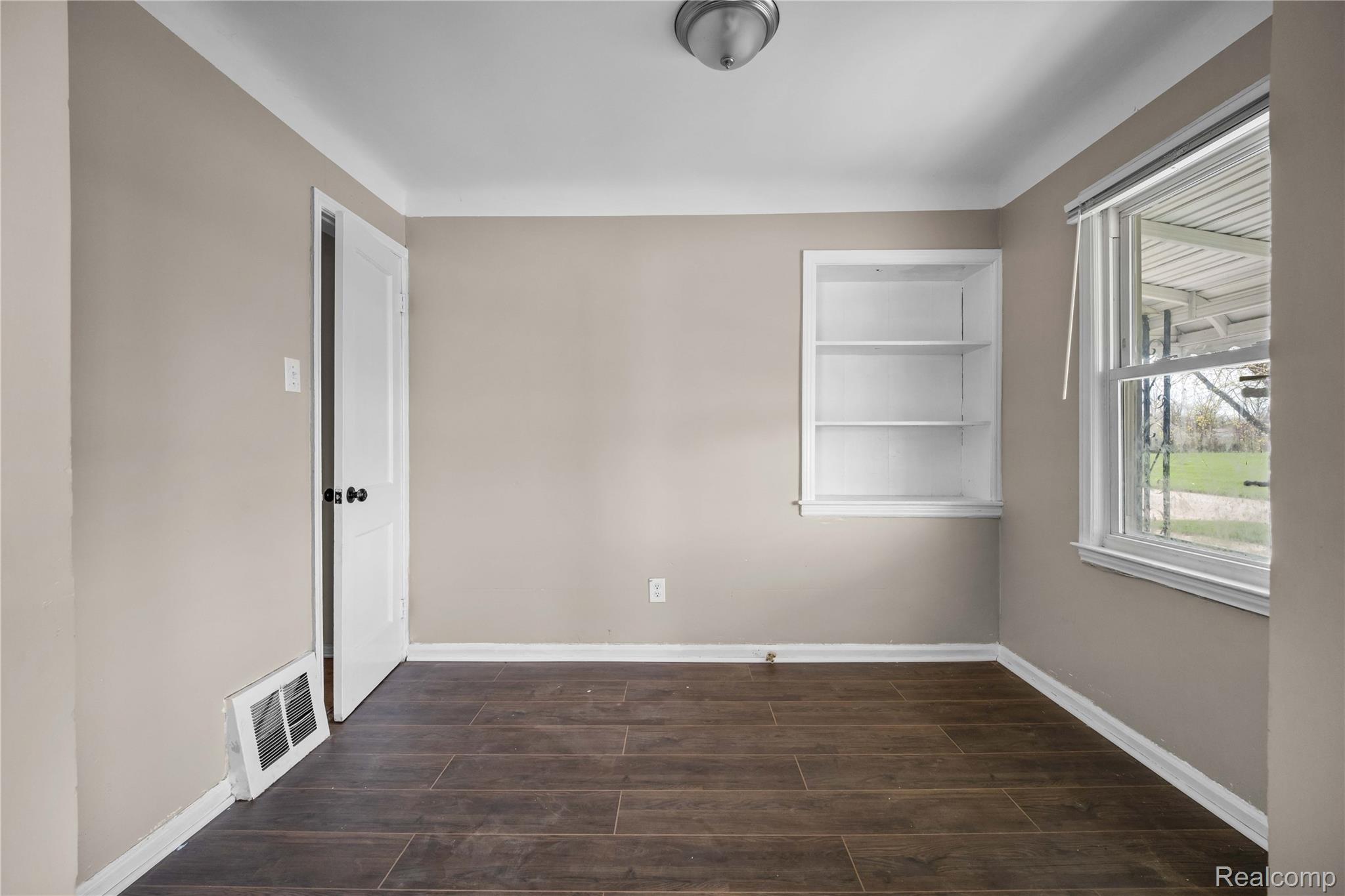 4049 Williams Street Inkster, MI 48141 - Photo 7 of 21 Spare room with wood tiled floors and built in features