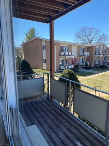 a view of a chairs and table in the balcony