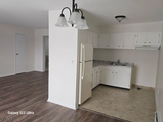 a utility room with cabinets washer and dryer