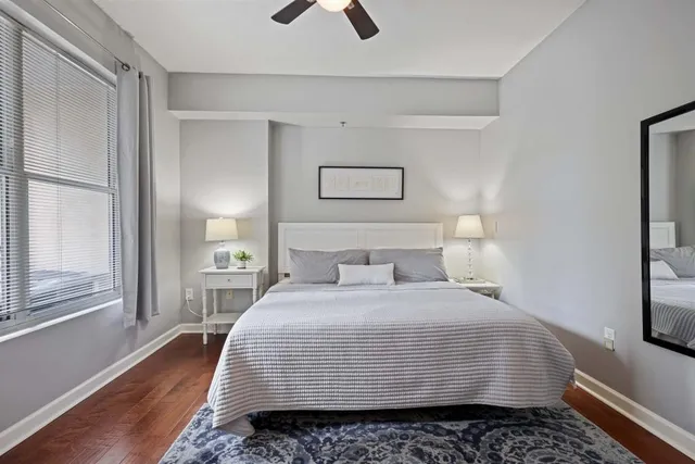 a bedroom with a bed and wooden floor