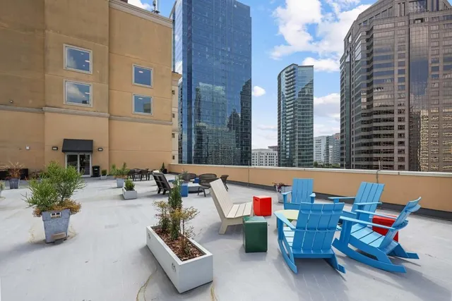 a view of a patio with table and chairs potted plants