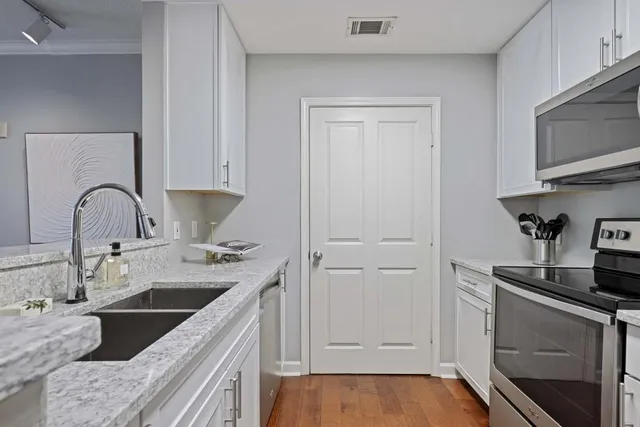 a kitchen with a sink and a refrigerator