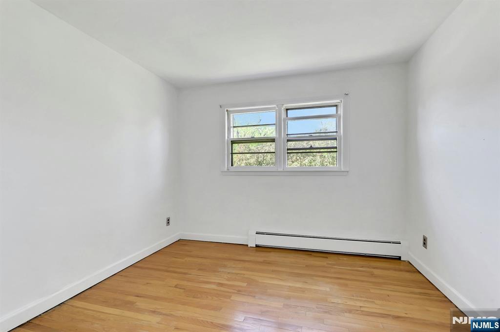 20 Blue Hill Road Norwood, NJ 07648 - Photo 26 of 49 wooden floor in an empty room with a window