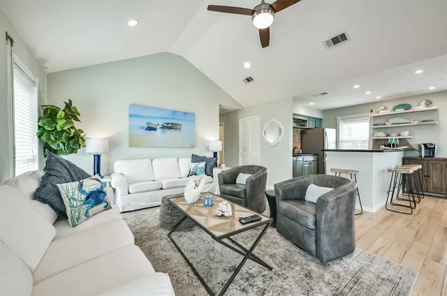 a living room with furniture kitchen view and a table