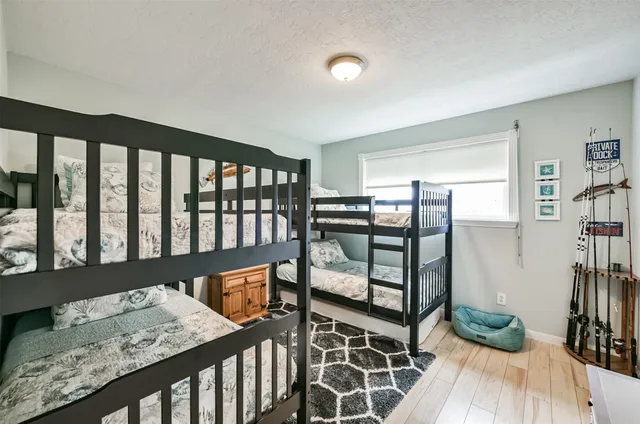 a view of a hallway with wooden floor and windows