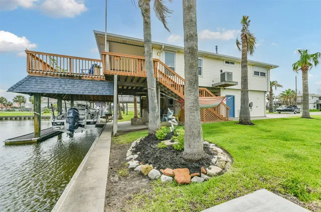 a view of a house with a yard and sitting area