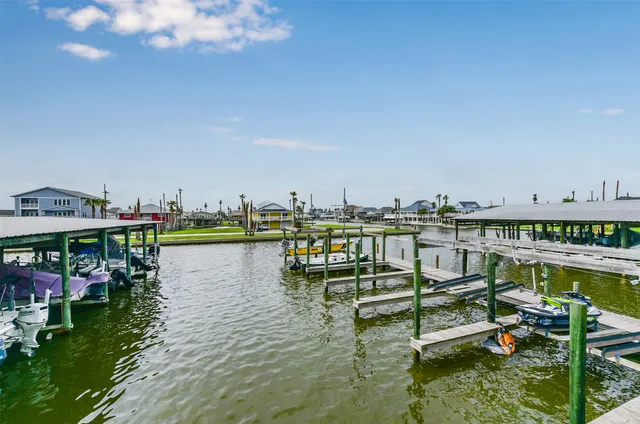 a view of water with boats and trees in the background