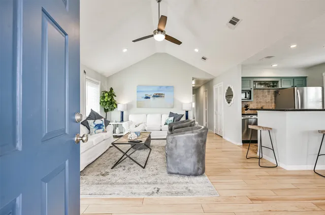 a living room with furniture and kitchen view