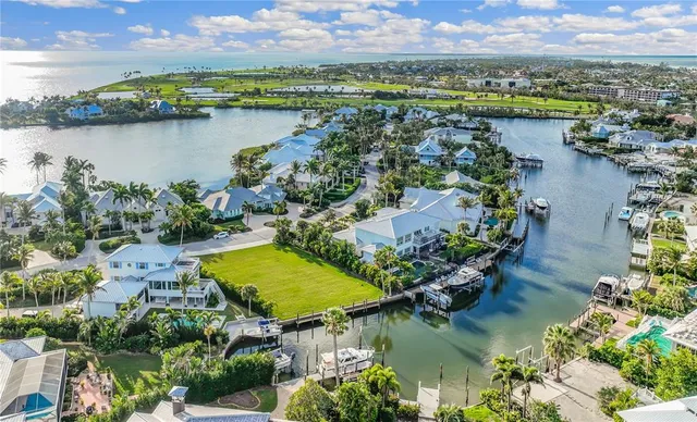an aerial view of residential houses with outdoor space and lake view