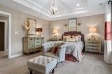 8670 Burr Rdg Circle Crown Point, IN 46307 - Photo 24 of 36 a bedroom with furniture and a chandelier