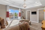 8670 Burr Rdg Circle Crown Point, IN 46307 - Photo 30 of 36 a bedroom with a bed and a chandelier