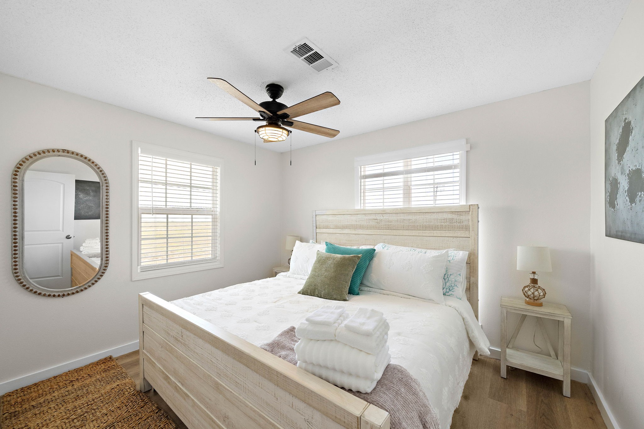 104 Marlin Avenue Freeport, TX 77541 - Photo 21 of 43 a bedroom with a large bed and a chandelier