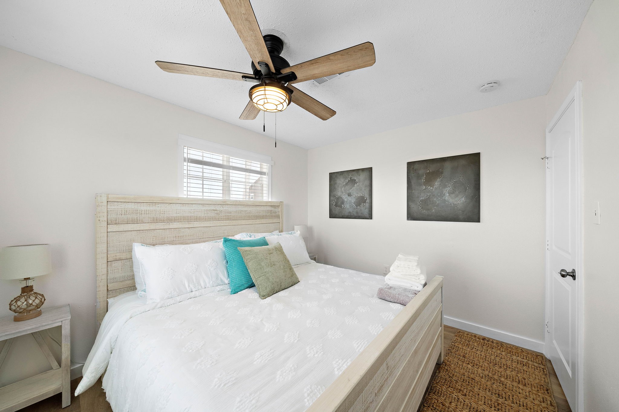 104 Marlin Avenue Freeport, TX 77541 - Photo 22 of 43 a bedroom with a bed and a chandelier