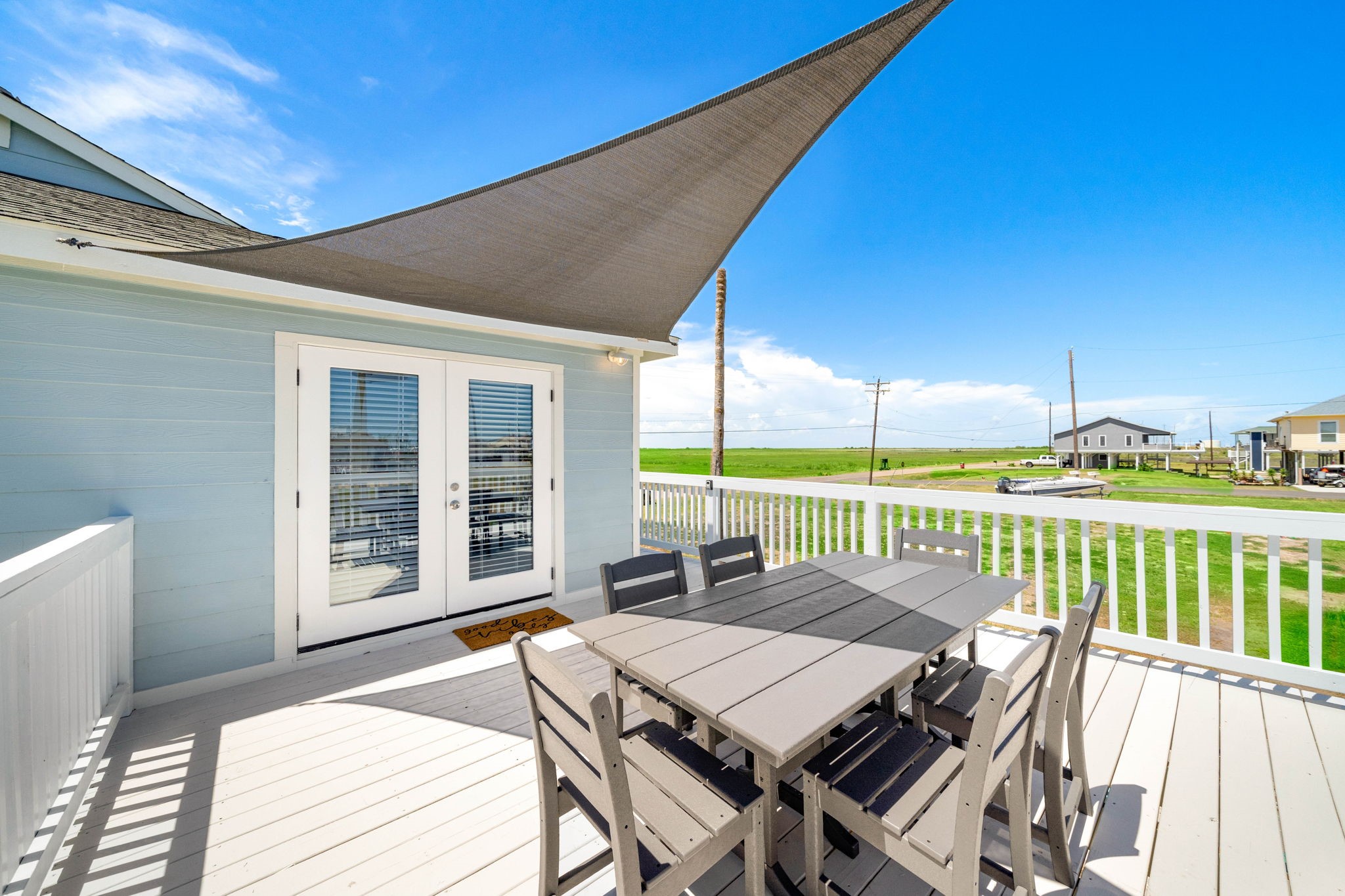 104 Marlin Avenue Freeport, TX 77541 - Photo 28 of 43 a view of a patio with wooden floor table and chairs