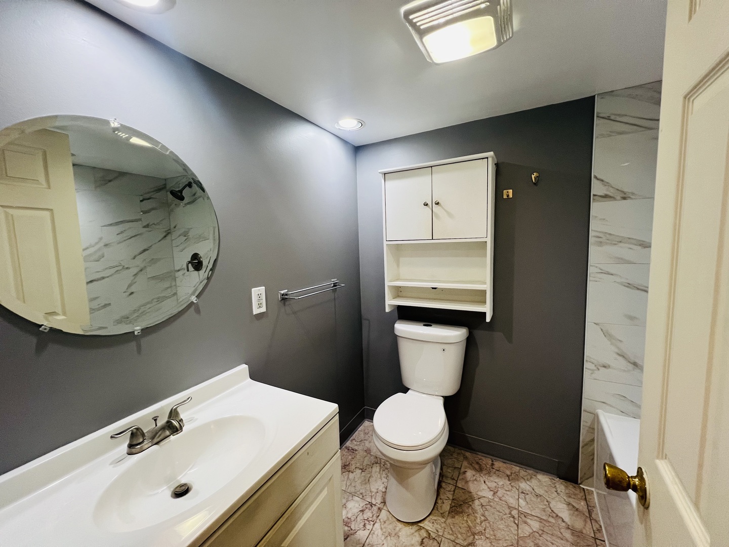 3516 North Keating Avenue, Unit G Chicago, IL 60641 - Photo 4 of 20 a bathroom with a toilet sink and mirror