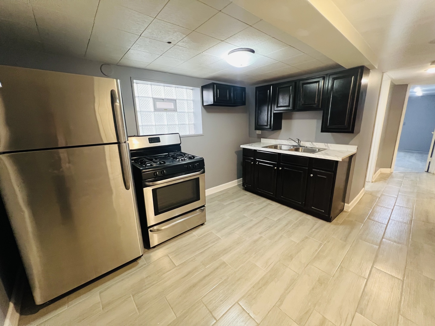 3516 North Keating Avenue, Unit G Chicago, IL 60641 - Photo 6 of 20 a kitchen with stainless steel appliances granite countertop a refrigerator and a stove