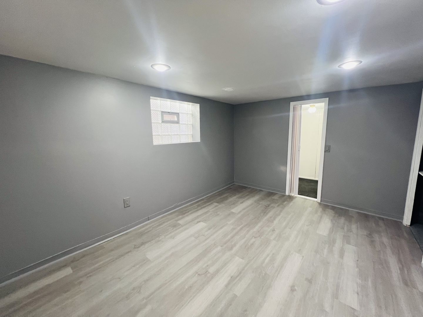 3516 North Keating Avenue, Unit G Chicago, IL 60641 - Photo 8 of 20 an empty room with wooden floor and windows