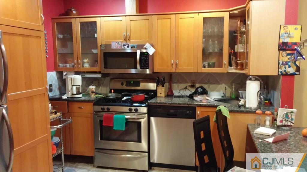 37 Rainford Road Edison, NJ 08820 - Photo 1 of 18 a kitchen with stainless steel appliances a stove and a microwave