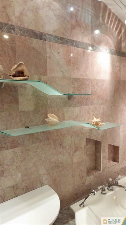 37 Rainford Road Edison, NJ 08820 - Photo 10 of 18 a bathroom with a sink a toilet and a mirror