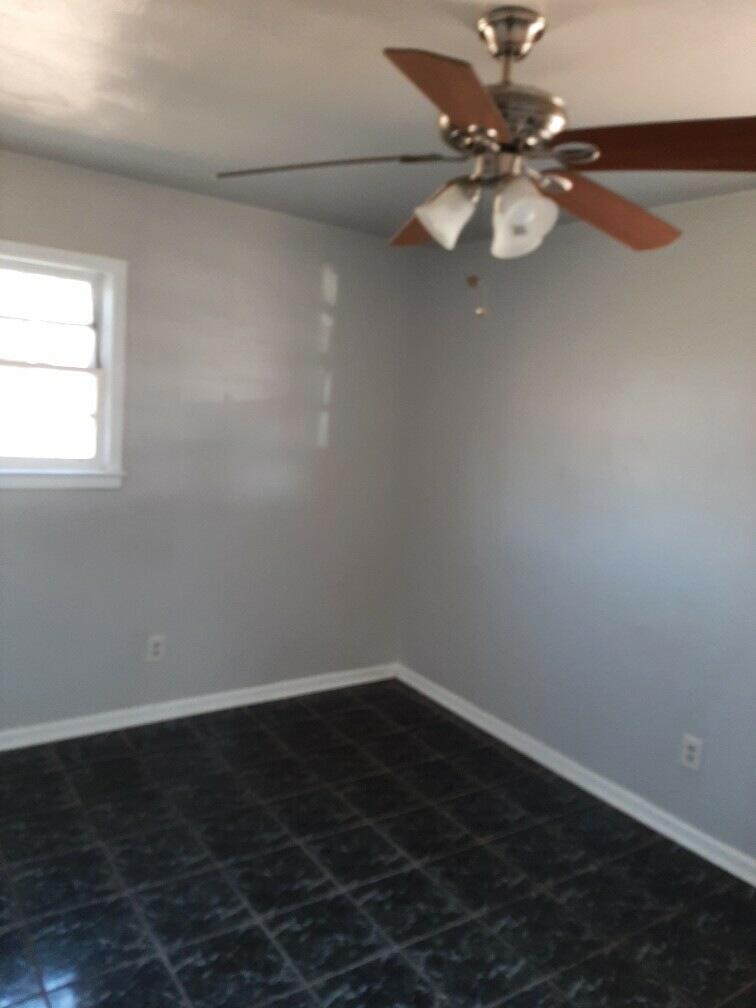 2403 East 5th Street Lubbock, TX 79403 - Photo 5 of 8 a view of a room with wooden floor and a ceiling fan