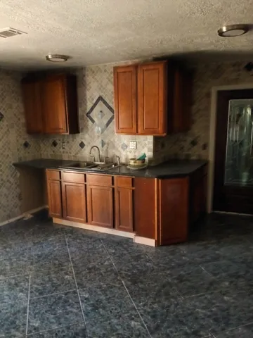 a view of a room with wooden floor and a window