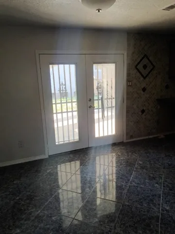 a kitchen with granite countertop a sink and cabinets