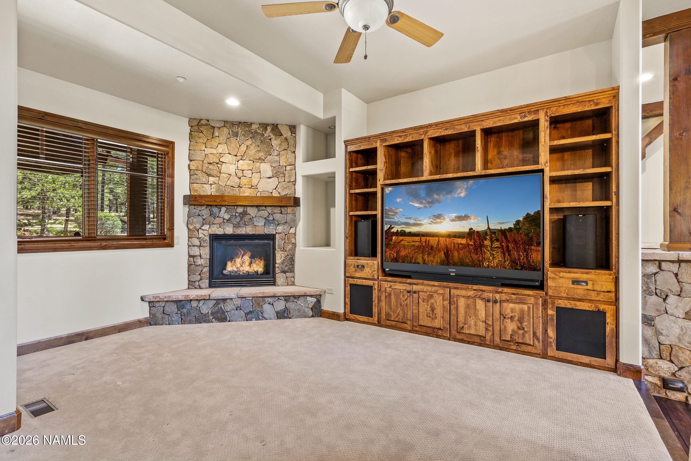 2214 East Del Rae Drive Flagstaff, AZ 86005 - Photo 11 of 45 a living room with furniture flat screen tv and a fireplace