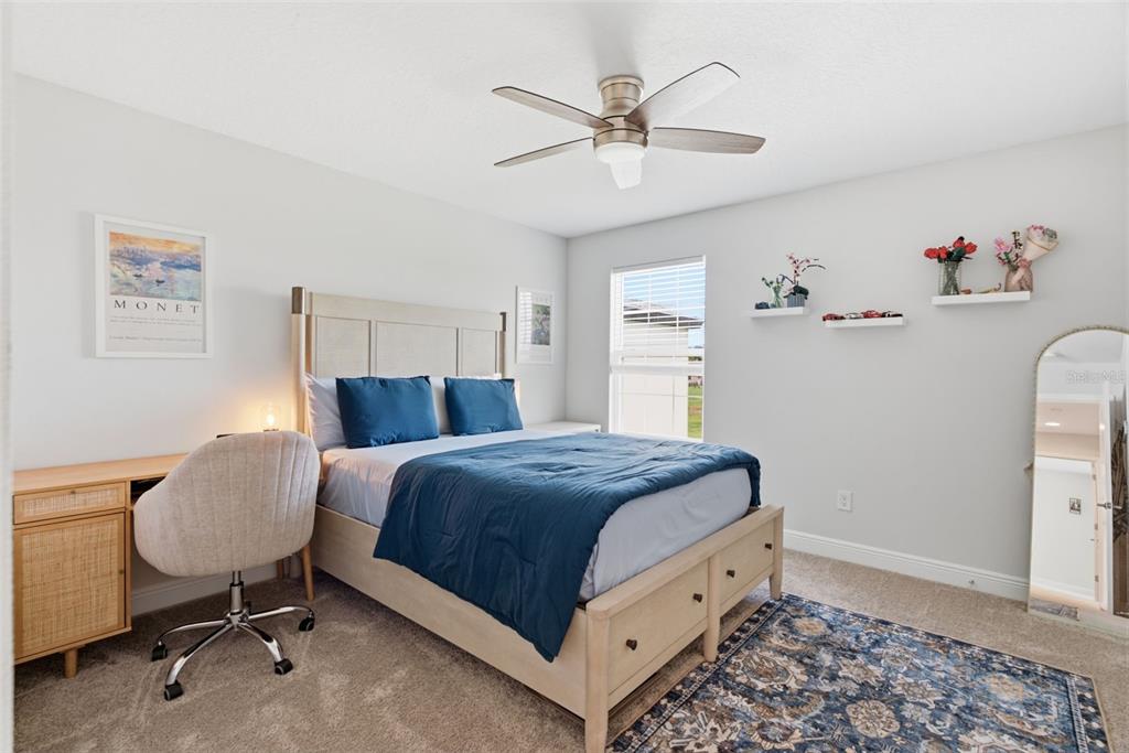 12970 Steed Trce Loop Lithia, FL 33547 - Photo 45 of 57 a bedroom with a bed and a chandelier