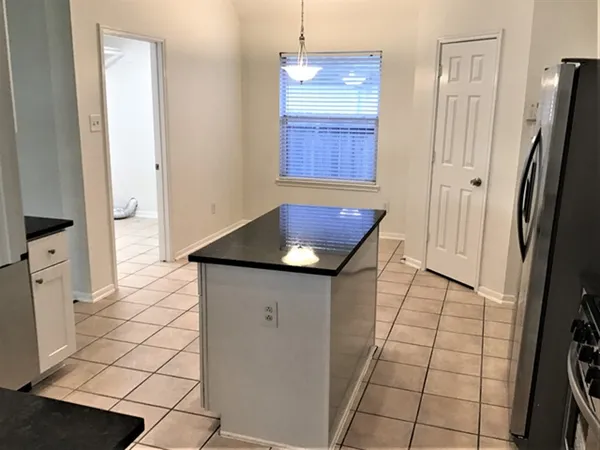 a kitchen with granite countertop a sink and a stove top oven