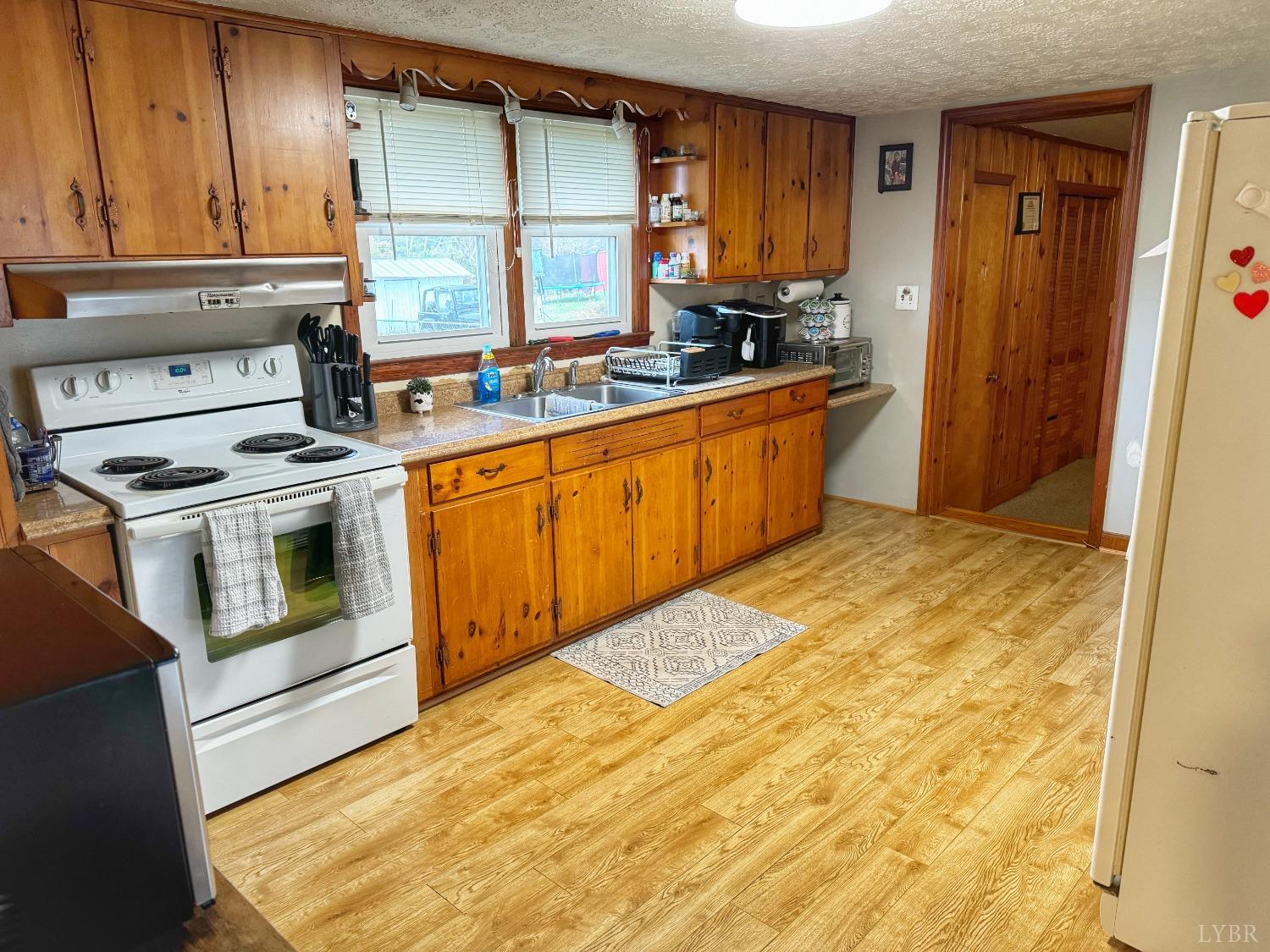 2961 Grit Road Hurt, VA 24563 - Photo 4 of 13 a kitchen with stainless steel appliances granite countertop a stove a sink and a microwave