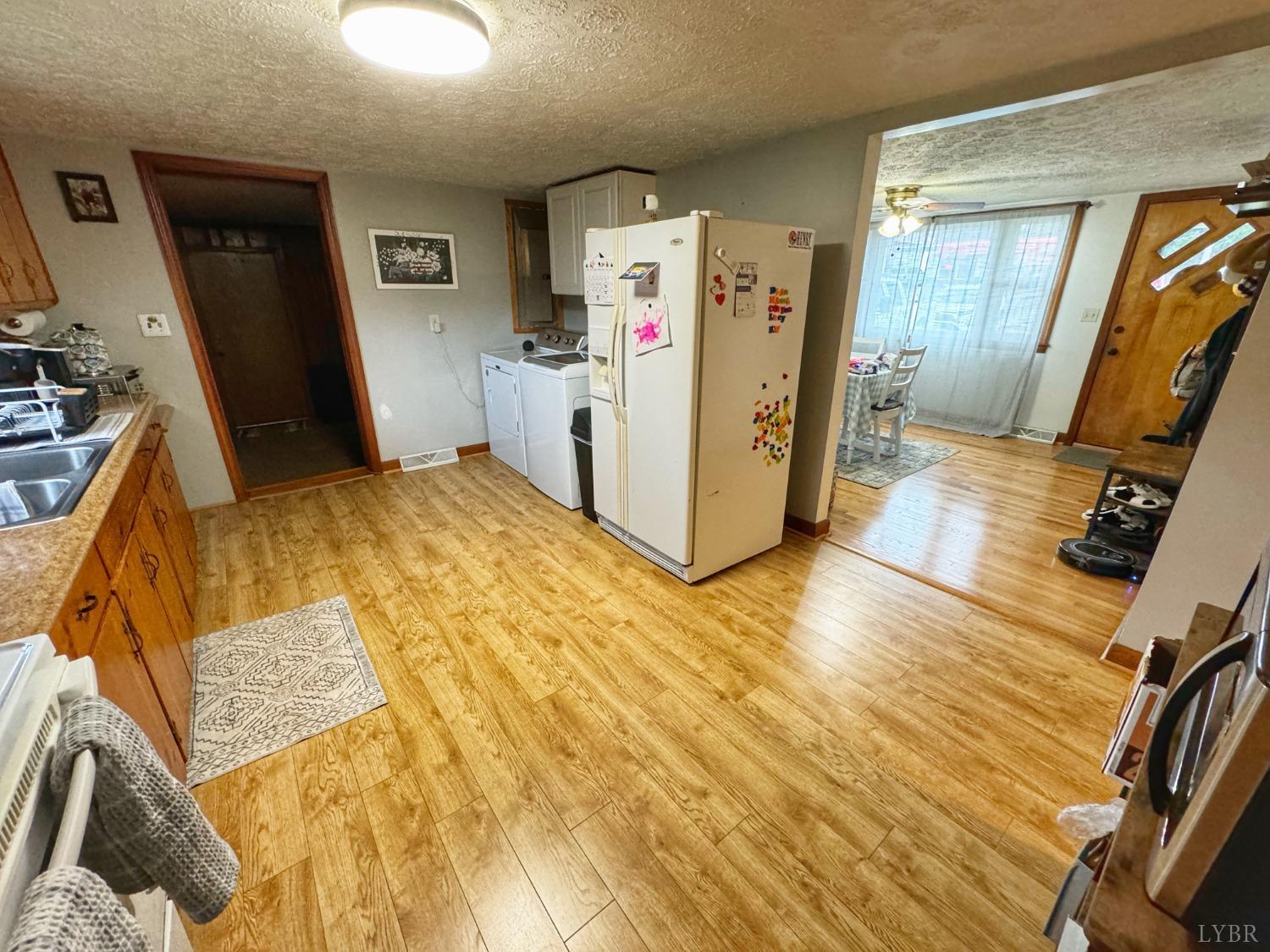 2961 Grit Road Hurt, VA 24563 - Photo 5 of 13 a view of a kitchen with fridge and wooden floor