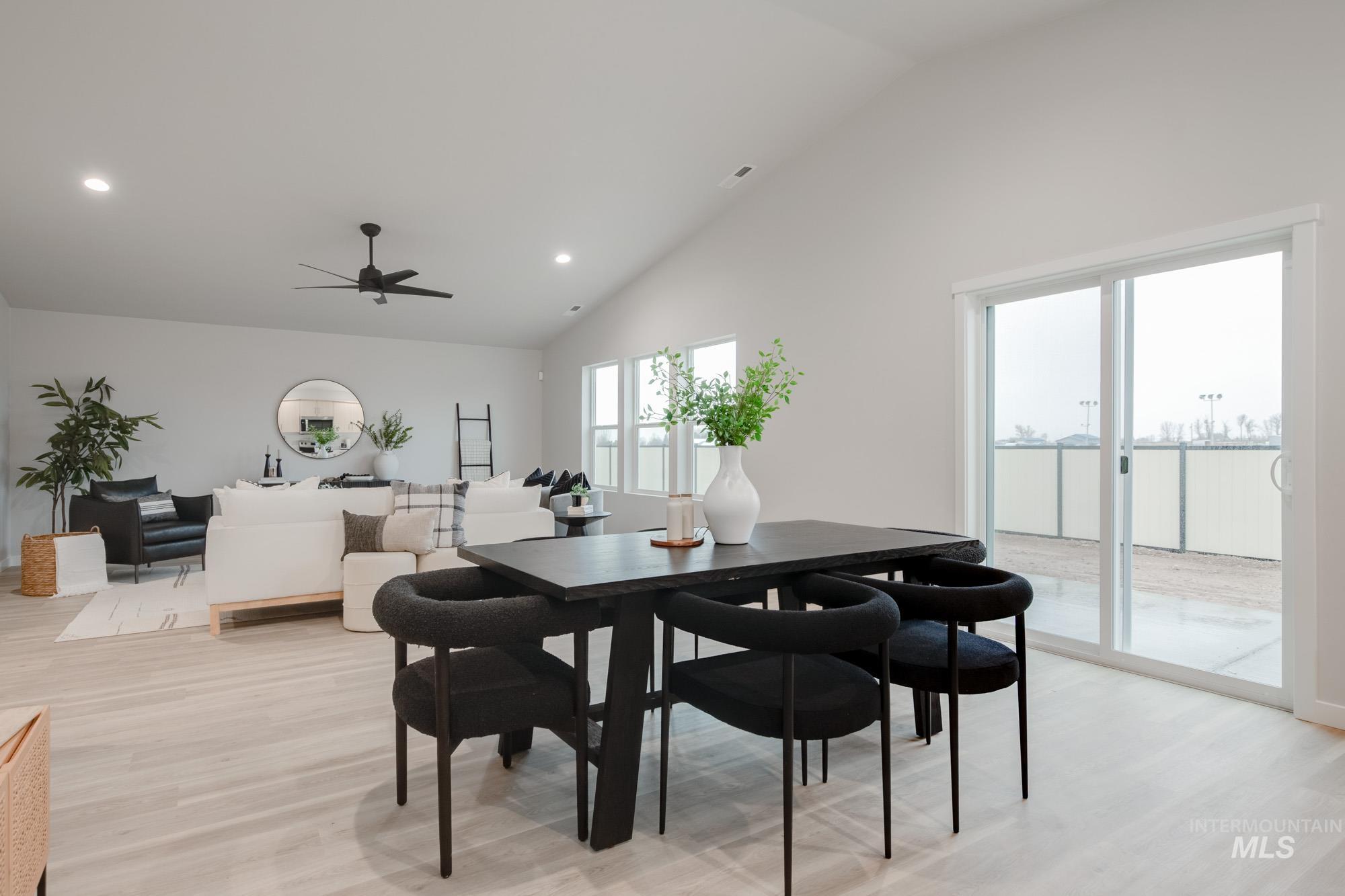 1776 West Unforgettable Street Meridian, ID 83642 - Photo 11 of 27 Dining room featuring light wood-type flooring, recessed lighting, ceiling fan, and high vaulted ceiling