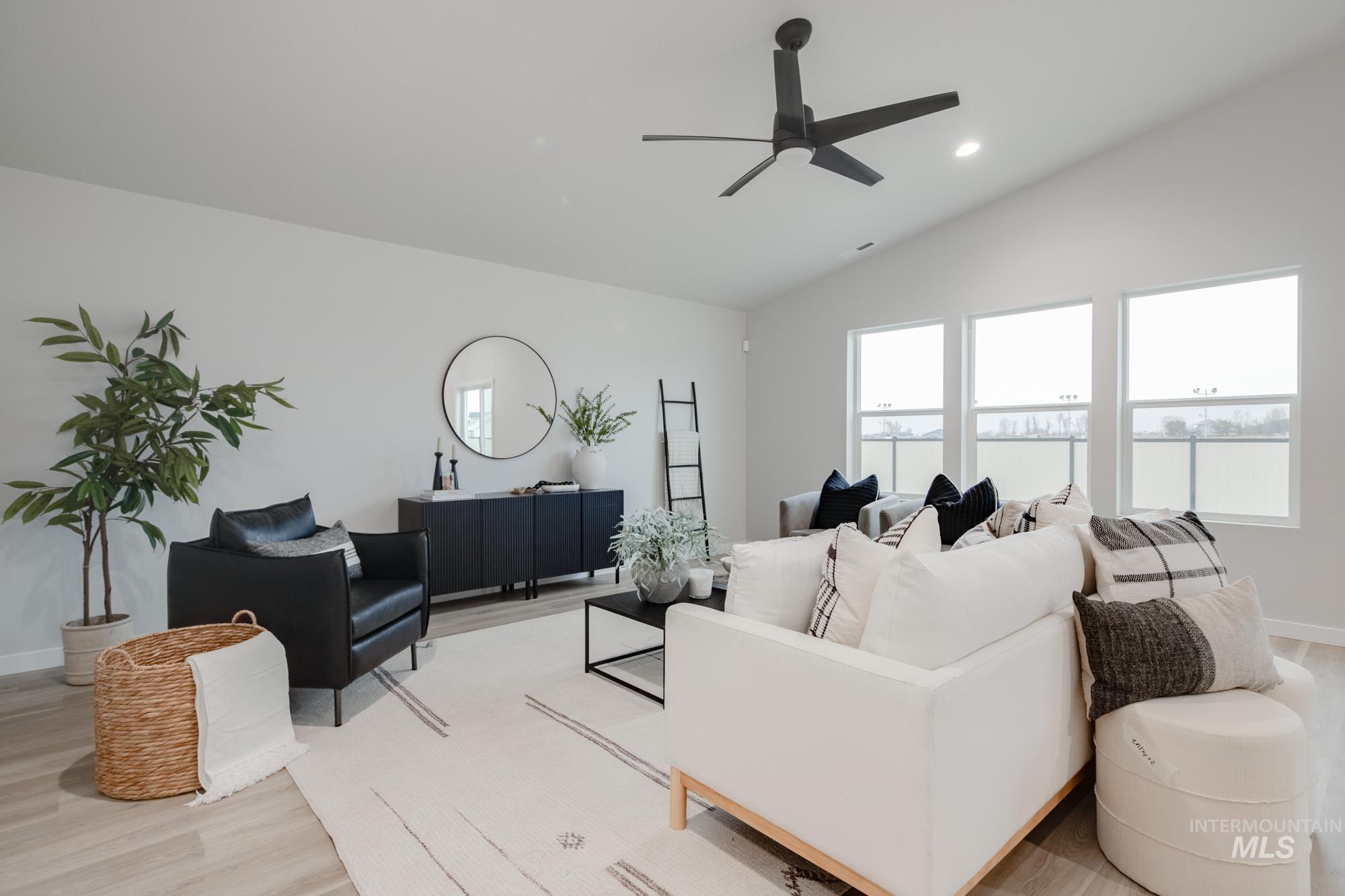 1776 West Unforgettable Street Meridian, ID 83642 - Photo 15 of 28 Living area featuring light wood-style floors, vaulted ceiling, a ceiling fan, and recessed lighting