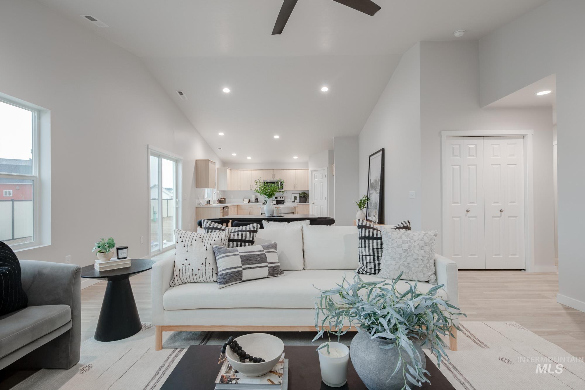 1776 West Unforgettable Street Meridian, ID 83642 - Photo 15 of 27 Living area with vaulted ceiling, recessed lighting, light wood-style floors, and ceiling fan