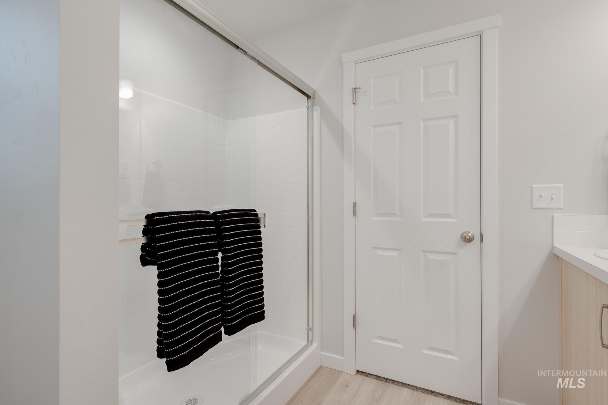 1776 West Unforgettable Street Meridian, ID 83642 - Photo 21 of 27 Full bath with vanity, a shower stall, and light wood-type flooring