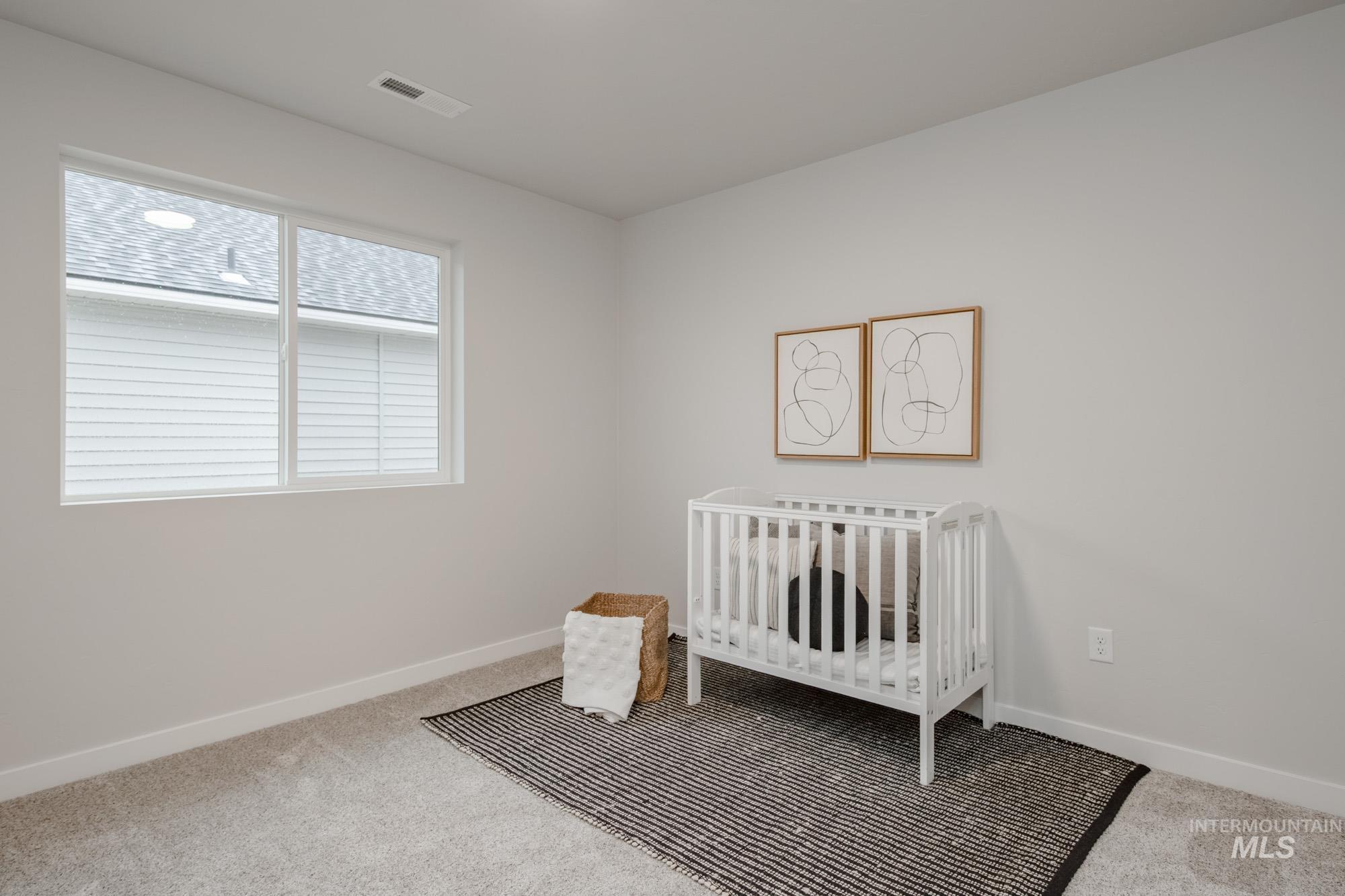 1776 West Unforgettable Street Meridian, ID 83642 - Photo 24 of 28 Bedroom with a crib and light carpet