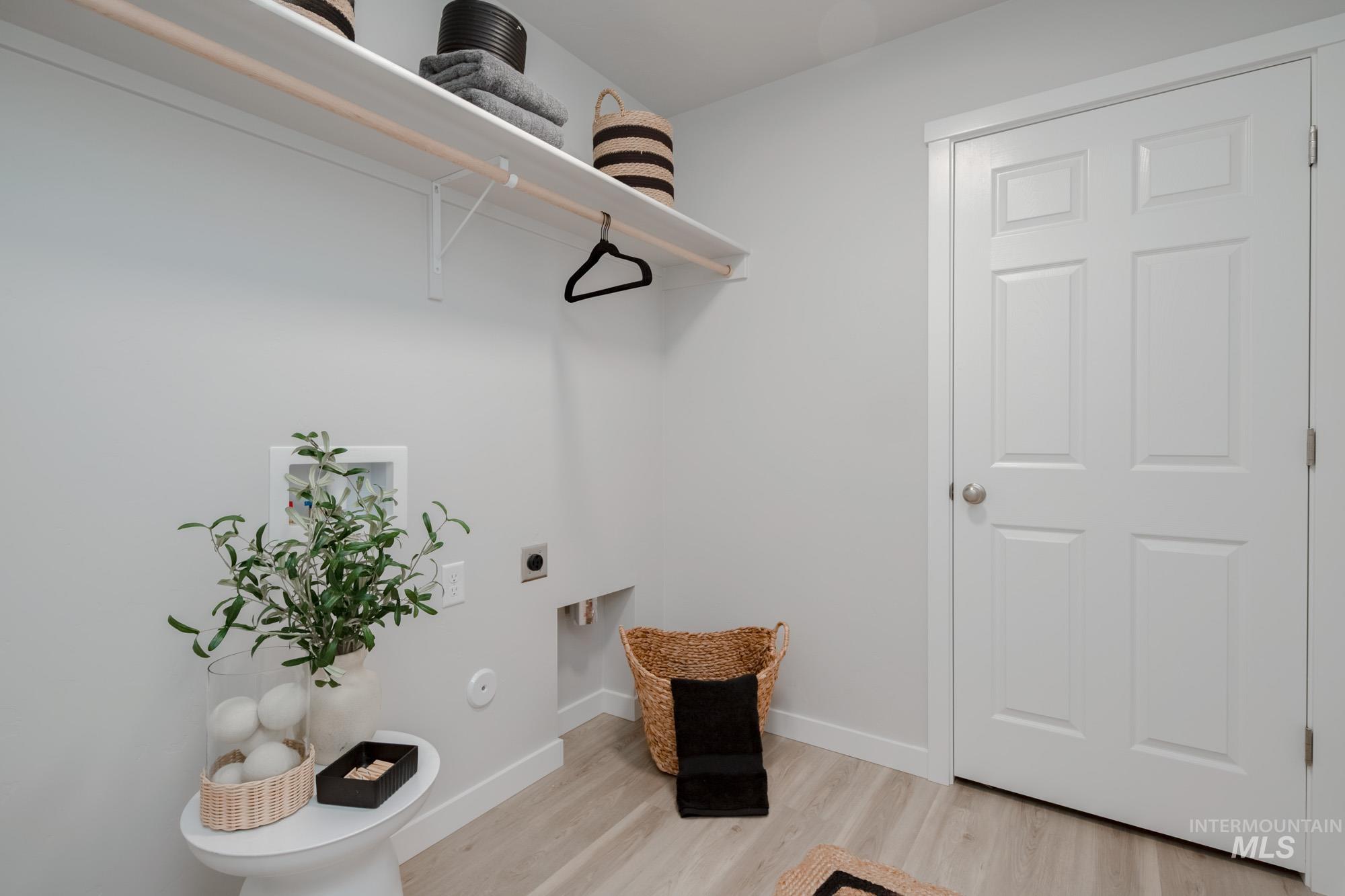 1776 West Unforgettable Street Meridian, ID 83642 - Photo 27 of 27 Laundry room with light wood-type flooring, washer hookup, and electric dryer hookup